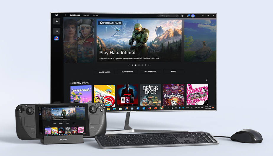 A docked Steam Deck connected to a monitor showing Halo Infinite, with a wireless keyboard and mouse.