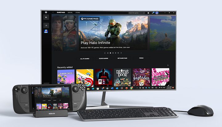 A docked Steam Deck connected to a monitor showing Halo Infinite, with a wireless keyboard and mouse.