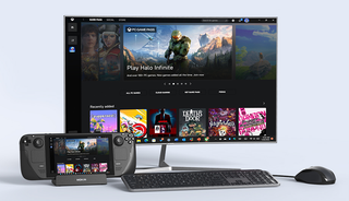 A docked Steam Deck connected to a monitor showing Halo Infinite, with a wireless keyboard and mouse.