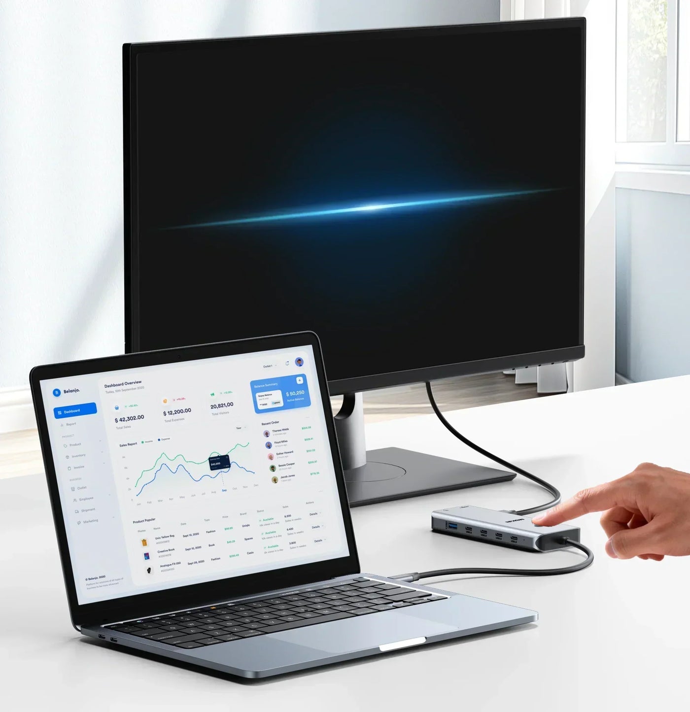 Laptop connected to multi-functional USB-C hub, displaying data dashboard - showcasing hub's expanded connectivity.